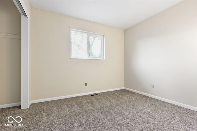 unfurnished bedroom with carpet, a closet, visible vents, and baseboards