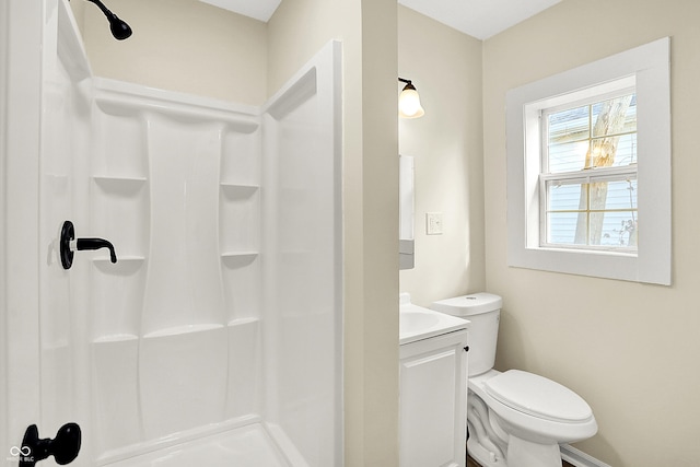 bathroom featuring walk in shower, vanity, and toilet