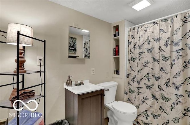 bathroom featuring a shower with shower curtain, vanity, and toilet