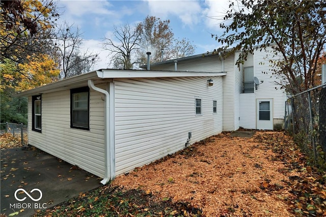 view of home's exterior featuring fence and a patio