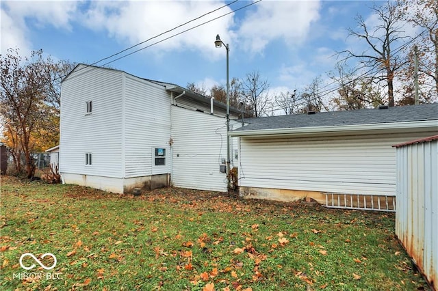 view of side of home with a lawn