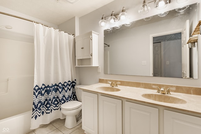 full bath with tile patterned floors, toilet, double vanity, and a sink