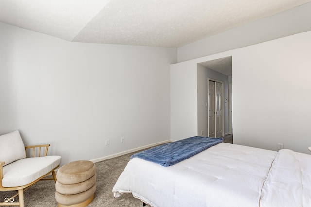 bedroom featuring baseboards, carpet floors, and a textured ceiling