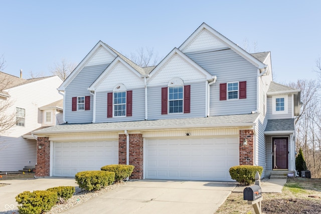 view of front of house featuring a garage, brick siding, driveway, and a shingled roof