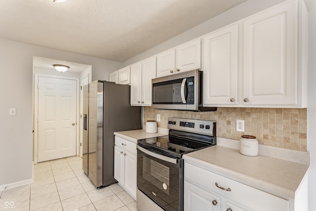 kitchen featuring backsplash, white cabinetry, stainless steel appliances, and light countertops