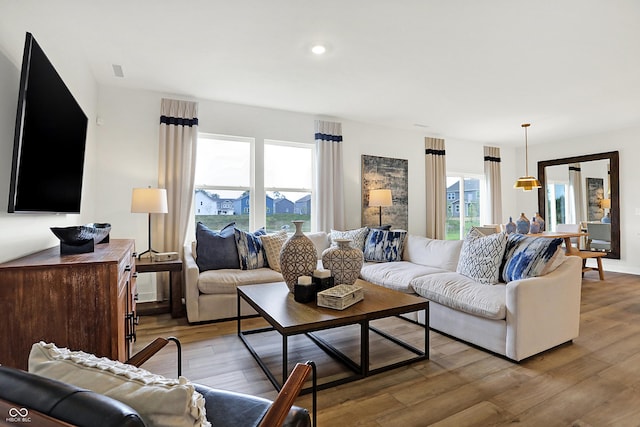 living area with recessed lighting and light wood-style floors