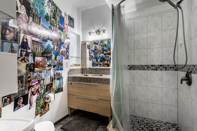bathroom with a stall shower and vanity