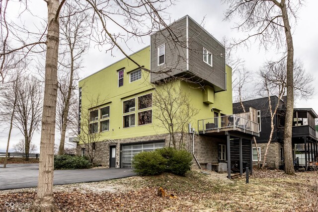 exterior space featuring stucco siding, driveway, and an attached garage