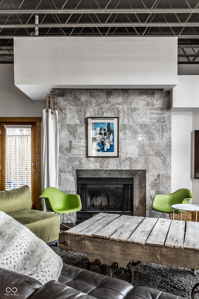 living area with a tiled fireplace