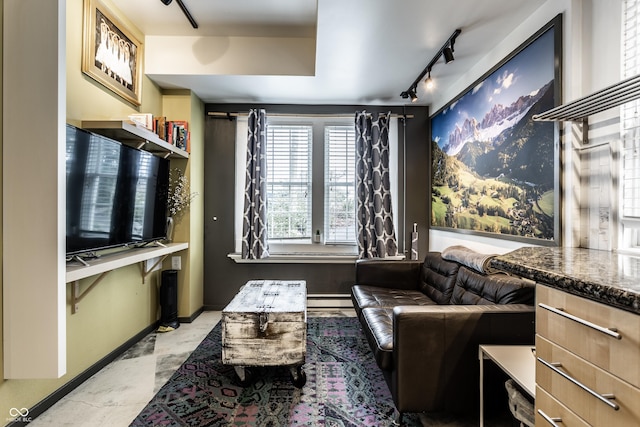 sitting room with track lighting, baseboards, and a baseboard radiator