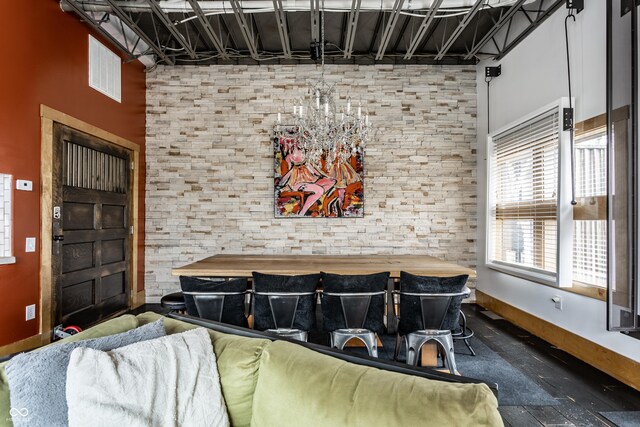 home theater room with a notable chandelier and baseboards