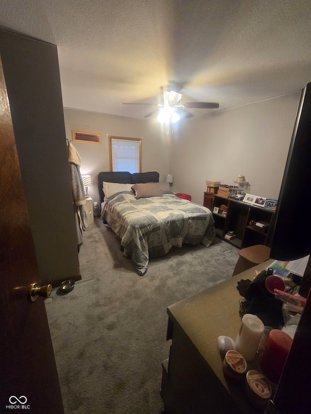 bedroom featuring a textured ceiling, carpet, and a ceiling fan