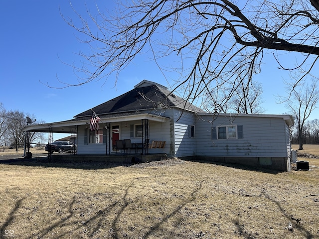 view of front of house with a porch and an attached carport