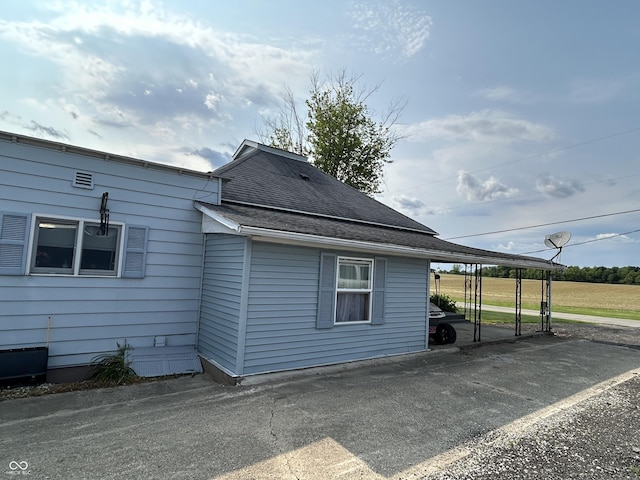 245 W Dixie Bee Rd, Veedersburg, IN 47987 - view of property exterior featuring a carport and roof with shingles