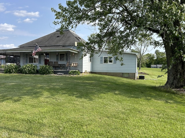 245 W Dixie Bee Rd, Veedersburg, IN 47987 - rear view of house featuring a porch, a lawn, central AC, and a shingled roof