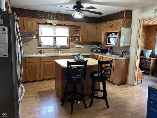 245 W Dixie Bee Rd, Veedersburg, IN 47987 - kitchen featuring freestanding refrigerator, a sink, light wood finished floors, under cabinet range hood, and brown cabinetry