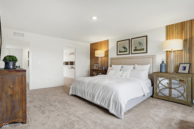 carpeted bedroom with visible vents and baseboards