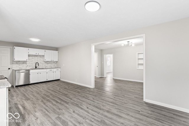 kitchen featuring dishwasher, light wood-type flooring, a sink, and white cabinets