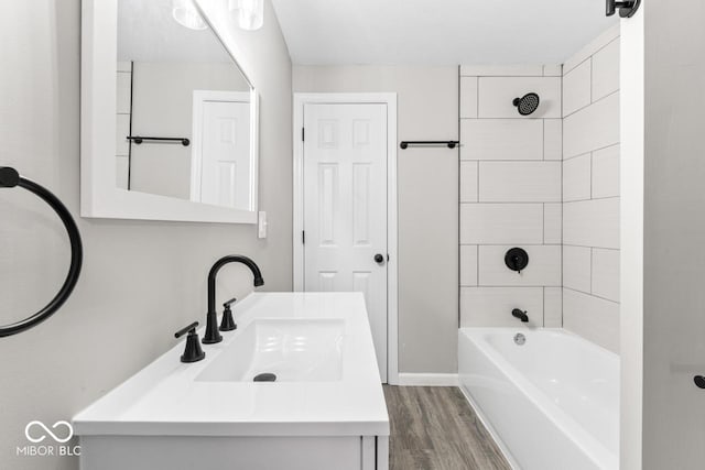 full bath with shower / bath combination, wood finished floors, and vanity