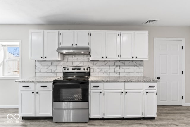 kitchen featuring stainless steel range with electric cooktop, white cabinetry, visible vents, and under cabinet range hood