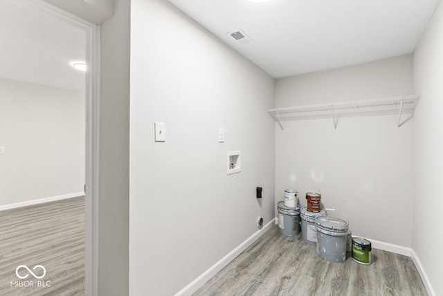 washroom with laundry area, visible vents, baseboards, wood finished floors, and washer hookup