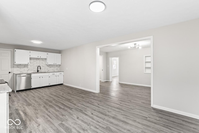 kitchen featuring dishwasher, a sink, white cabinetry, and light wood-style floors