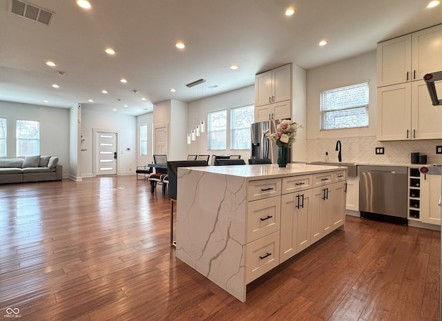 1818 N Cornell Ave, Indianapolis, IN 46202 - kitchen with appliances with stainless steel finishes, a sink, light stone counters, white cabinetry, and a kitchen island
