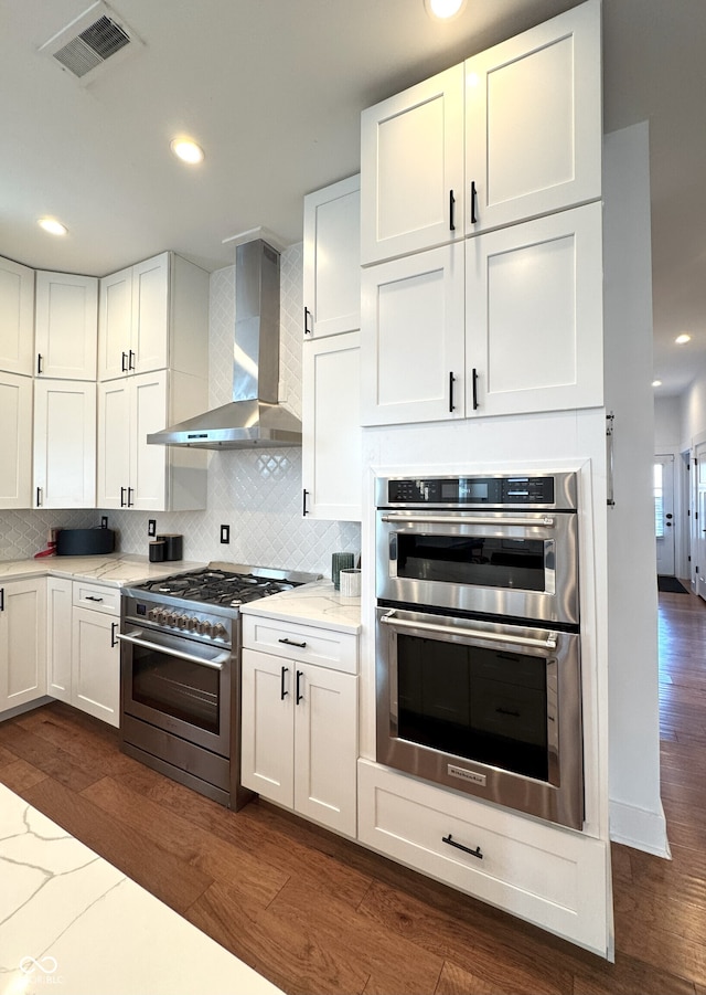 1818 N Cornell Ave, Indianapolis, IN 46202 - kitchen with wall chimney exhaust hood, stainless steel appliances, dark wood finished floors, backsplash, and recessed lighting