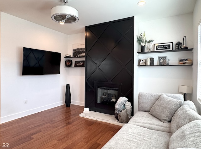 1818 N Cornell Ave, Indianapolis, IN 46202 - living area with wood finished floors, a large fireplace, and baseboards