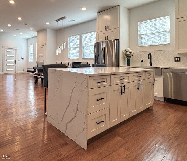1818 N Cornell Ave, Indianapolis, IN 46202 - kitchen with appliances with stainless steel finishes, light stone counters, dark wood-style floors, white cabinets, and recessed lighting