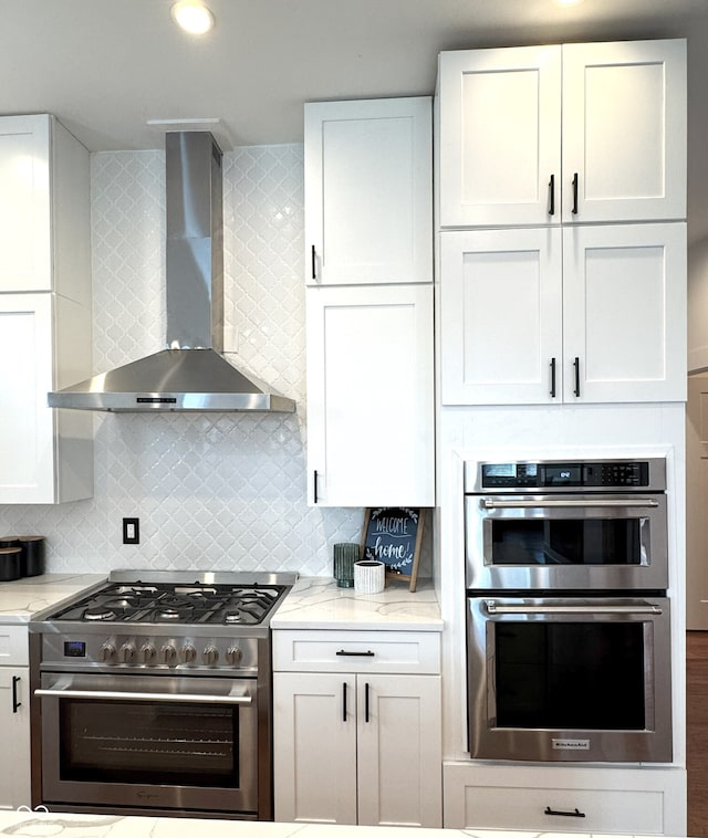 1818 N Cornell Ave, Indianapolis, IN 46202 - kitchen featuring appliances with stainless steel finishes, wall chimney range hood, and white cabinets