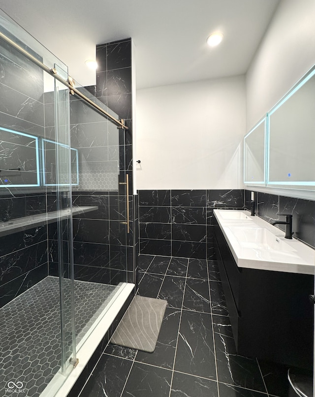 1818 N Cornell Ave, Indianapolis, IN 46202 - bathroom with marble finish flooring, a stall shower, double vanity, wainscoting, and tile walls