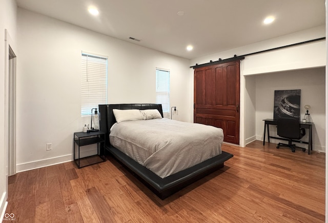 1818 N Cornell Ave, Indianapolis, IN 46202 - bedroom with wood finished floors, baseboards, recessed lighting, and a barn door