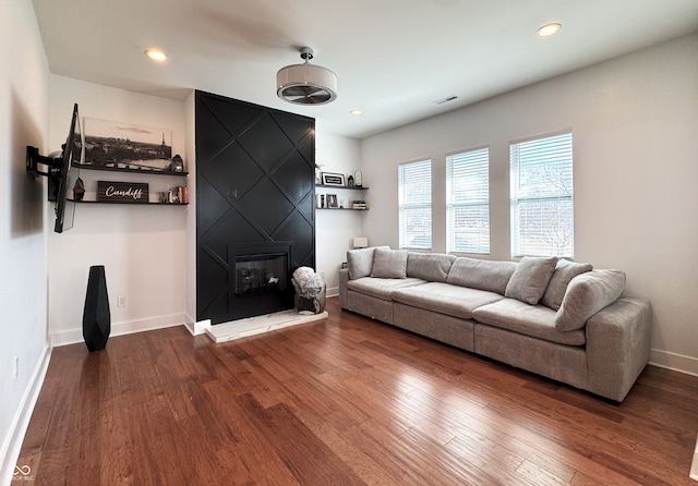 1818 N Cornell Ave, Indianapolis, IN 46202 - living area with dark wood-style floors, a large fireplace, baseboards, and recessed lighting