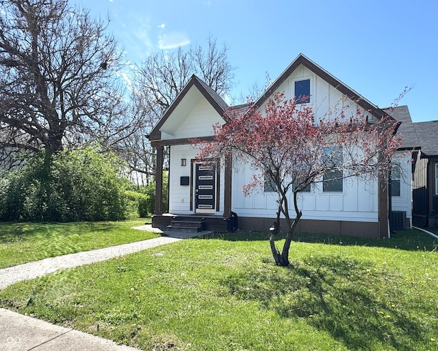 1818 N Cornell Ave, Indianapolis, IN 46202 - view of front facade with a front lawn, board and batten siding, and central AC unit