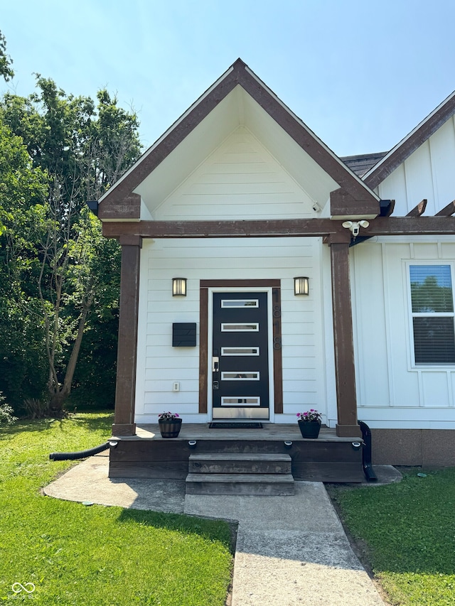 1818 N Cornell Ave, Indianapolis, IN 46202 - entrance to property featuring board and batten siding, a lawn, and a security system