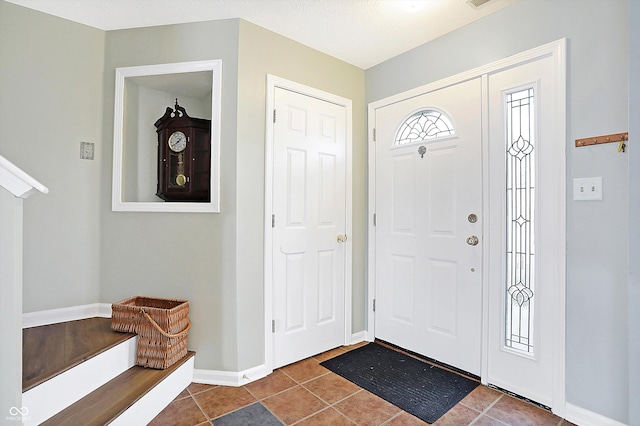 tiled foyer featuring baseboards