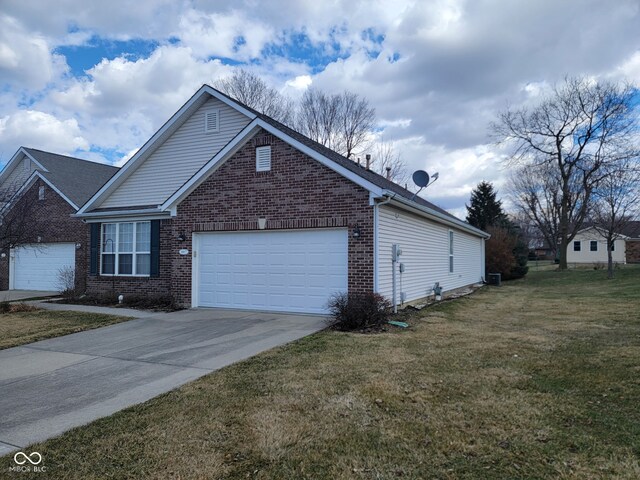 view of front of house with a garage, driveway, brick siding, and a front lawn