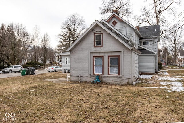 view of side of home featuring a lawn and a chimney