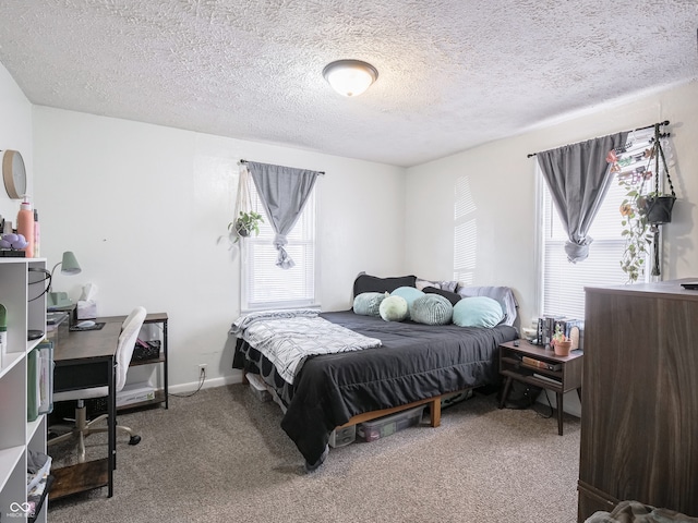 bedroom with a textured ceiling, carpet floors, and baseboards