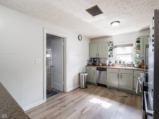 kitchen with open shelves, visible vents, stainless steel dishwasher, a textured ceiling, and light wood-type flooring