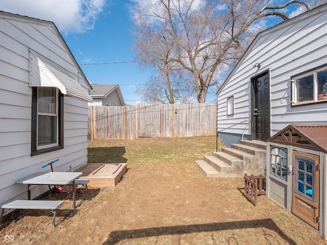 view of yard with entry steps and fence