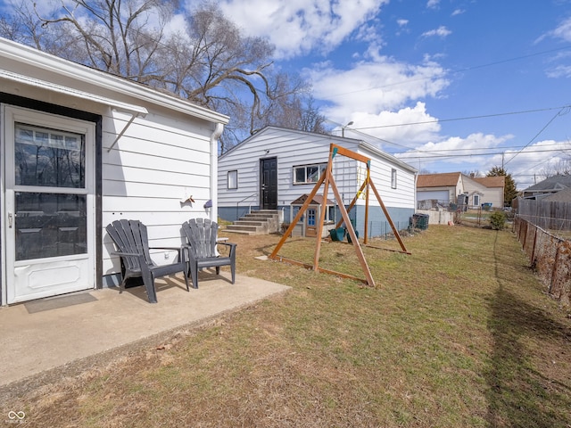 view of yard featuring entry steps, a patio, and a fenced backyard