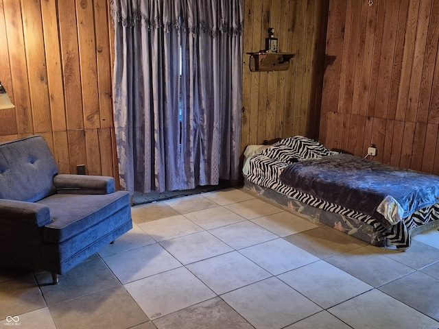 bedroom featuring wooden walls and tile patterned flooring