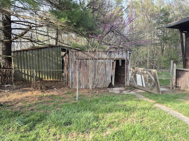 view of outbuilding featuring fence and an outdoor structure