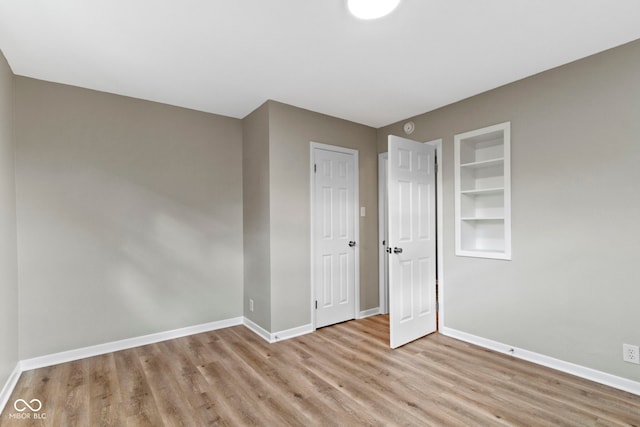 305 Bixler Rd, Indianapolis, IN 46227 - unfurnished bedroom with a closet, wood finished floors, and baseboards