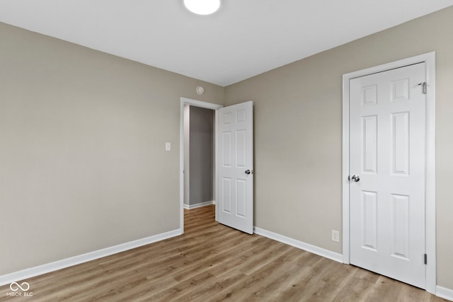305 Bixler Rd, Indianapolis, IN 46227 - unfurnished bedroom featuring light wood-style floors and baseboards