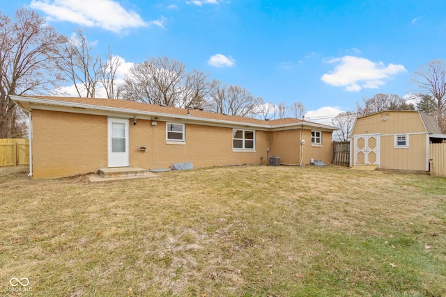 305 Bixler Rd, Indianapolis, IN 46227 - rear view of property featuring a yard, brick siding, cooling unit, and fence