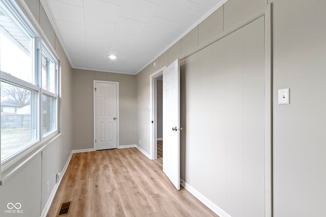 305 Bixler Rd, Indianapolis, IN 46227 - hallway featuring visible vents, crown molding, light wood-style flooring, and baseboards
