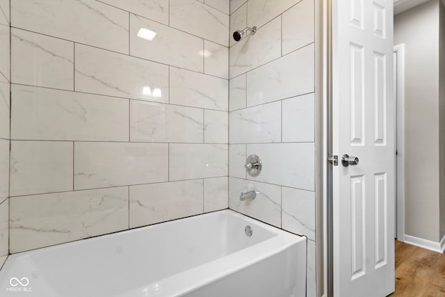 305 Bixler Rd, Indianapolis, IN 46227 - bathroom featuring bathtub / shower combination, wood finished floors, and baseboards
